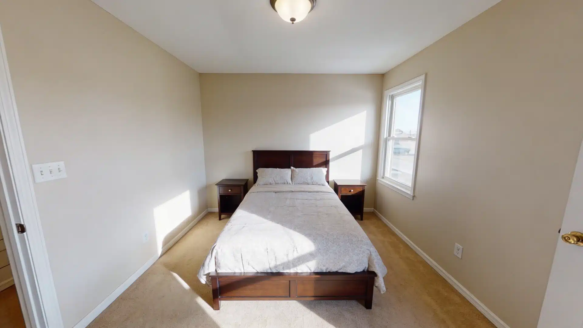 A small bedroom with a bed placed against the wall, leaving clear space around it for easy movement.