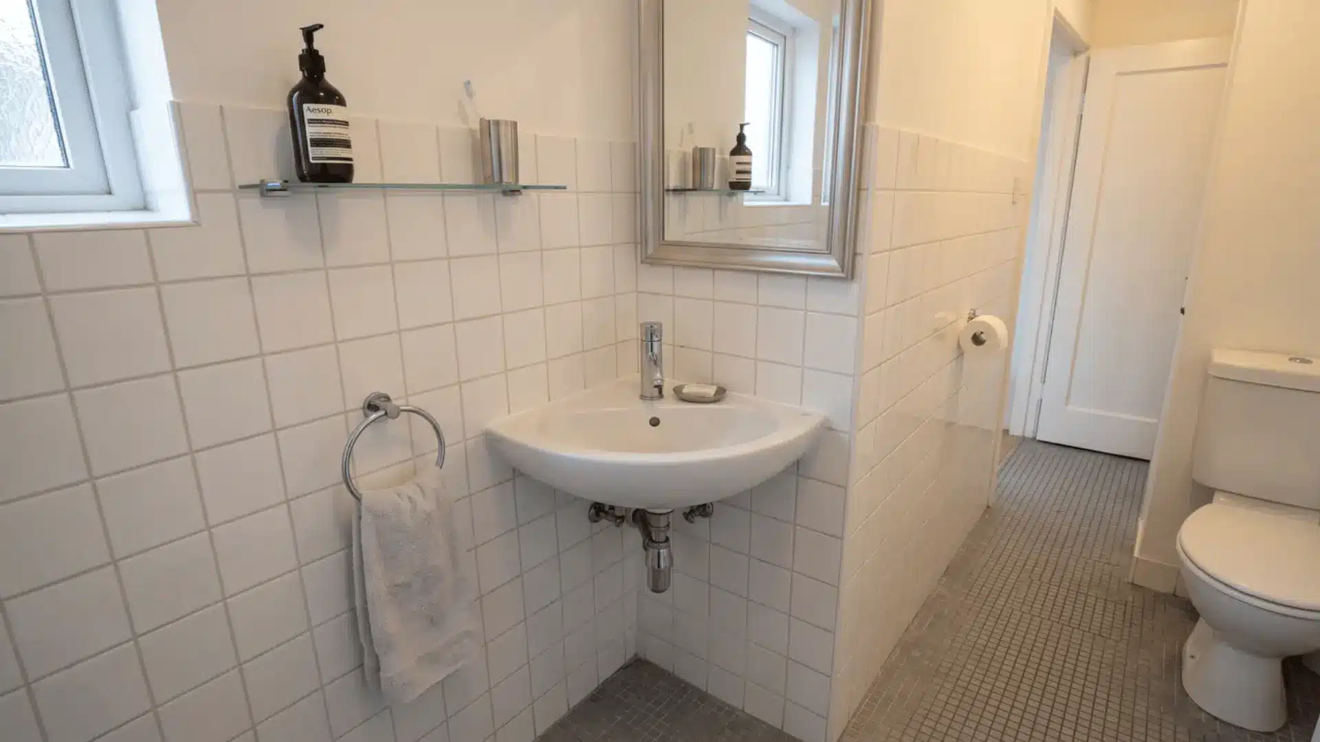 Corner sink fitted into a small bathroom layout
