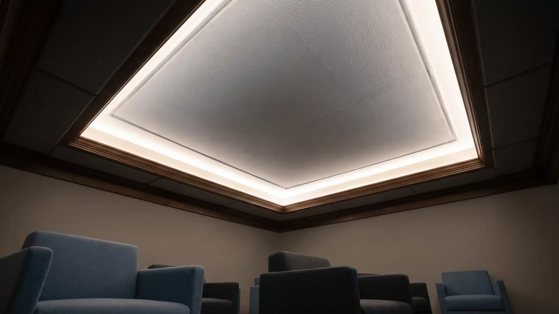 Fabric-lined tray ceiling creating soft acoustic surface within recessed ceiling design.
