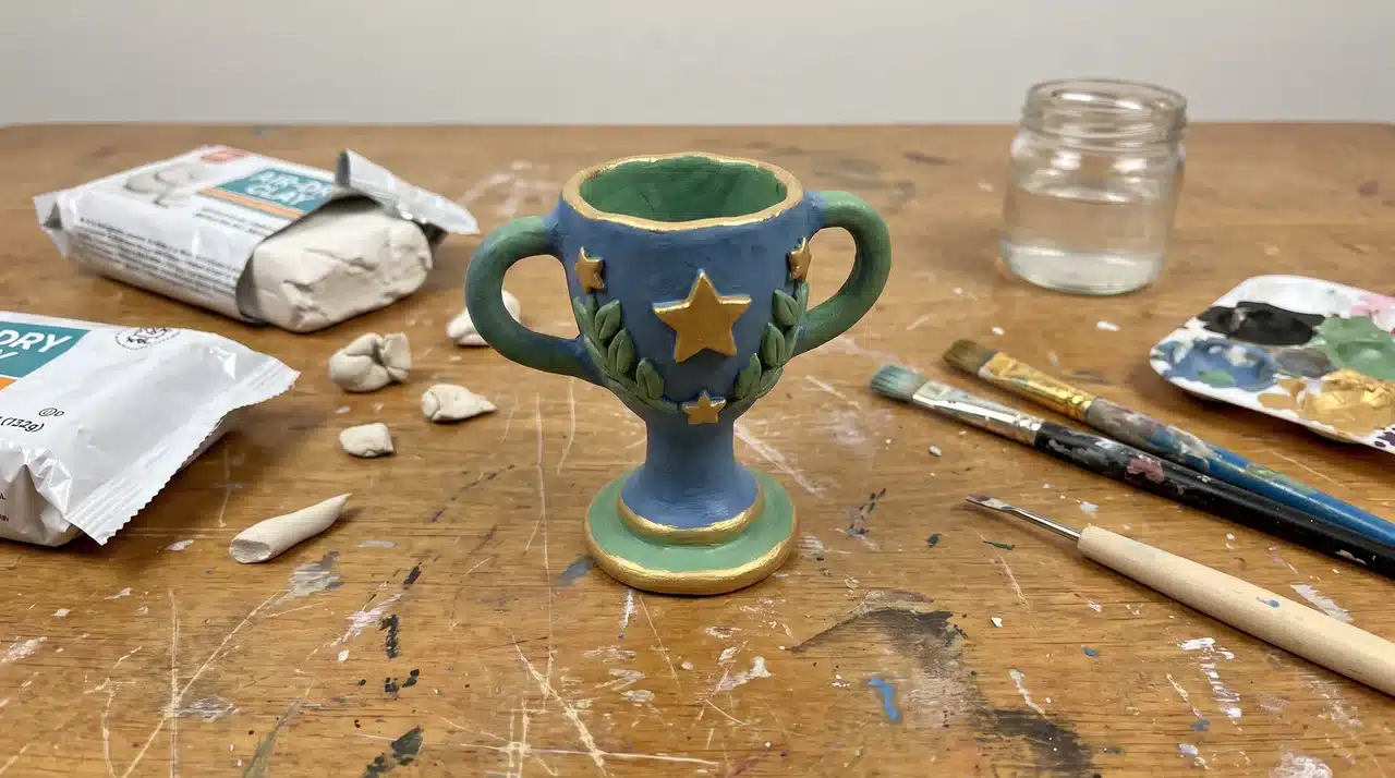 Handmade clay trophy on a desk with craft materials