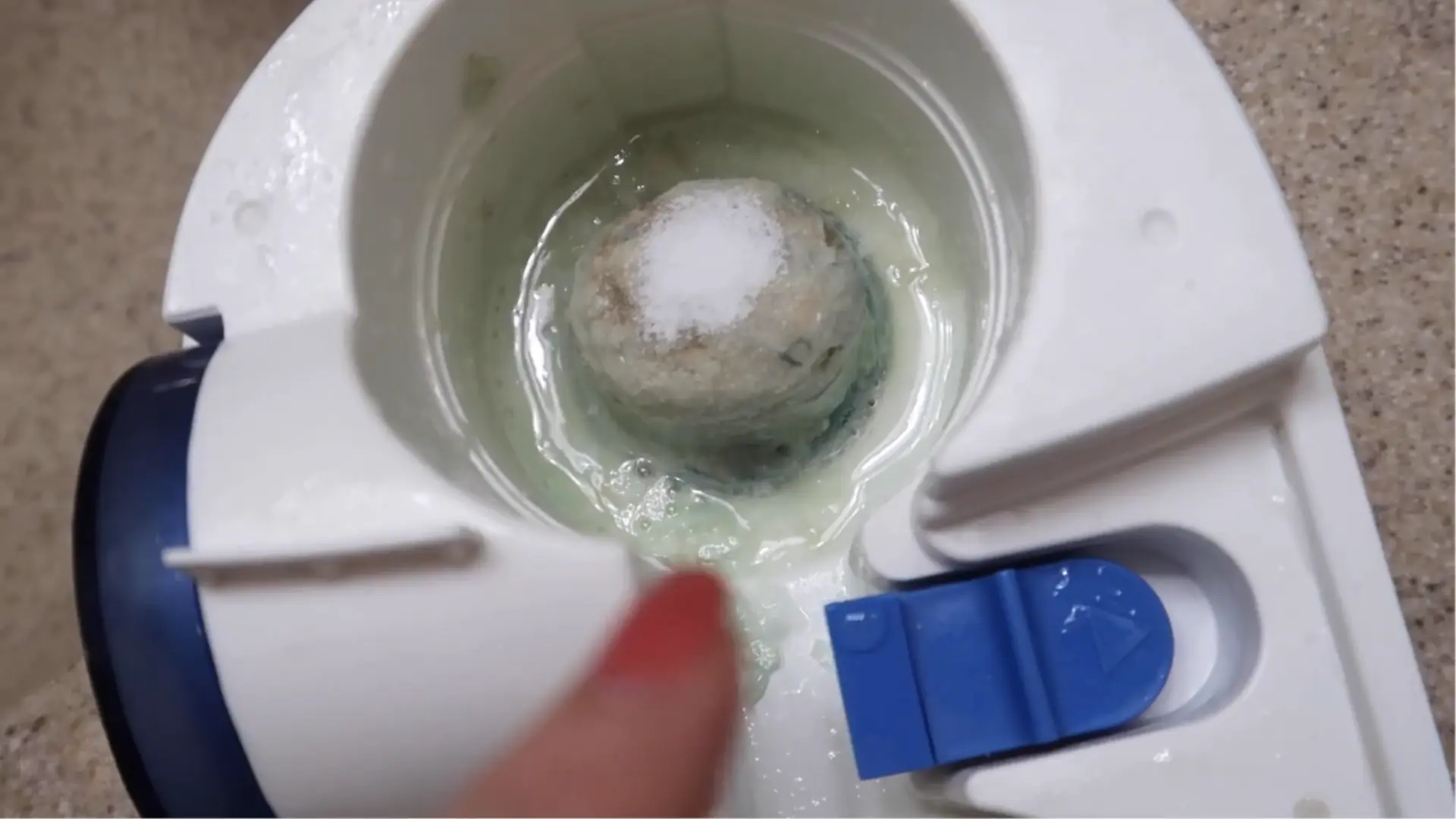 Citric acid soaking on the mineral-coated heating element inside a warm-mist humidifier base.