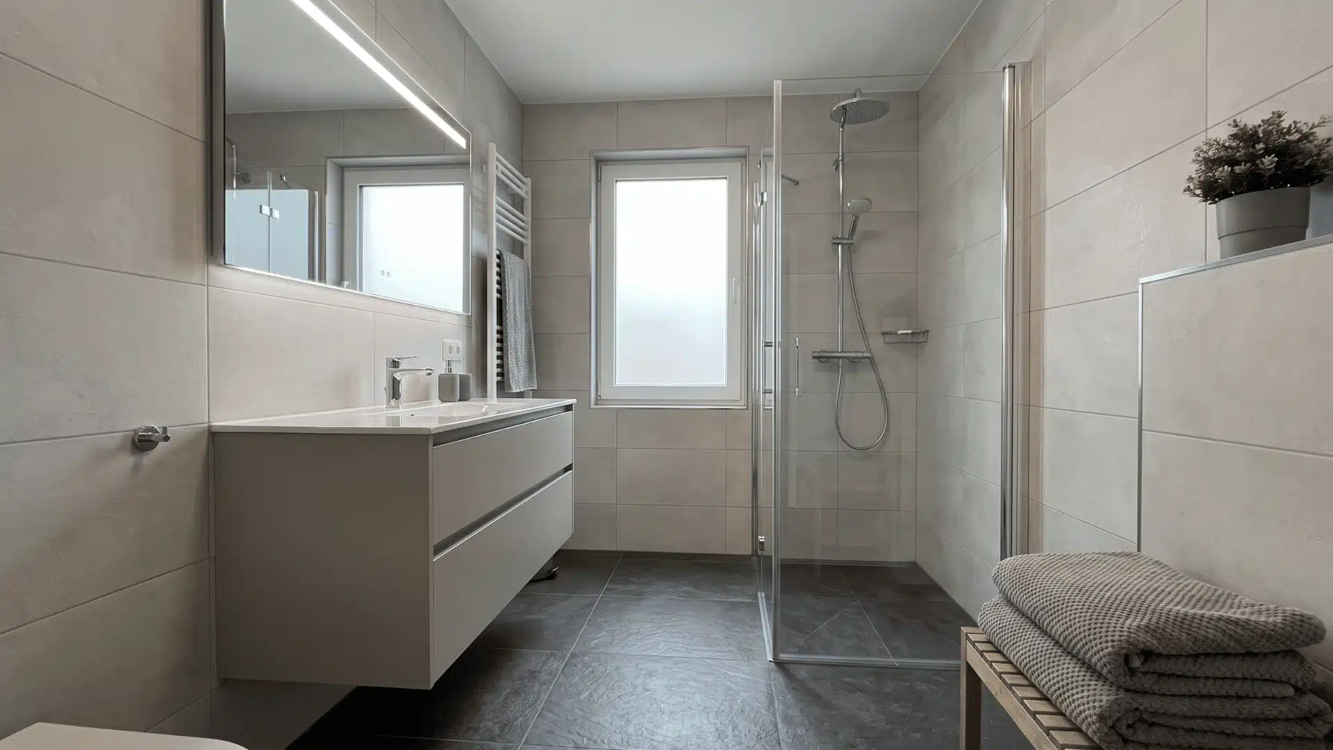 Bathroom with layered grey tones in walls and flooring