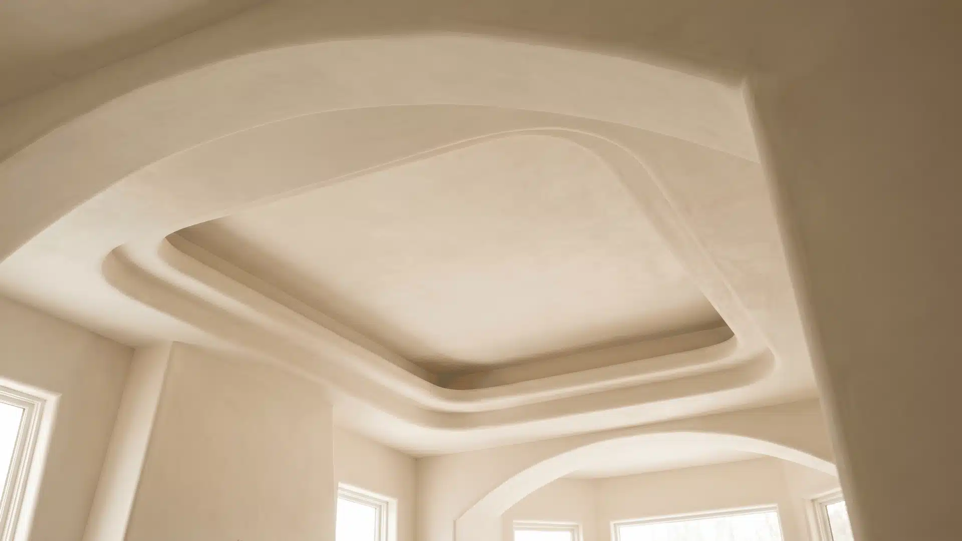 Plaster sculpted tray ceiling with soft curved forms inside recessed ceiling field.