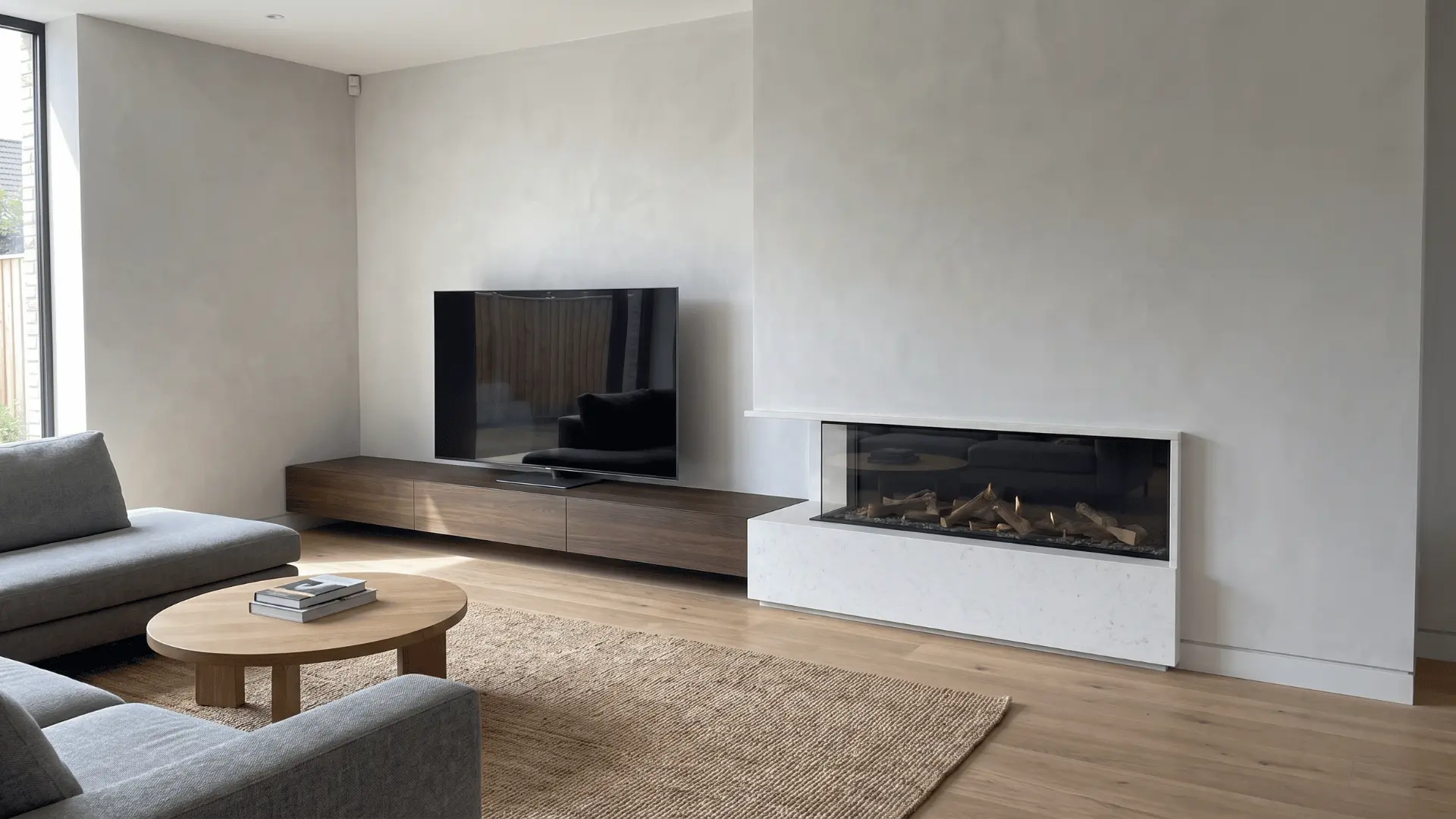  Low TV placement beside fireplace creating balanced viewing height.