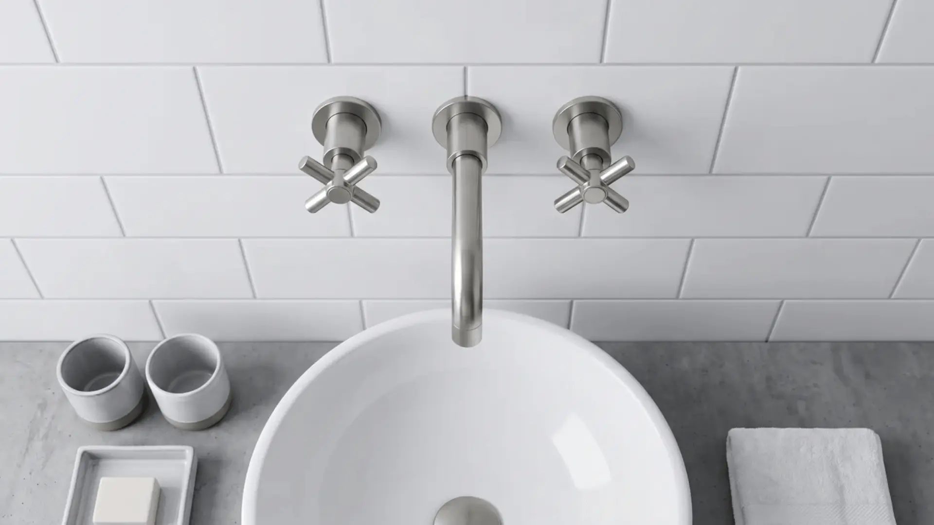 Wall-mounted faucet above small bathroom sink